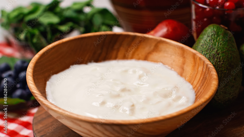 close up of fresh and tasty yogurt in wooden bowl close up of fresh and tasty yogurt in wooden bowl