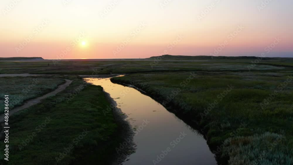 AERIAL - Sunset over Texel Islands river, Wadden, Netherlands, reverse rising shot AERIAL - Sunset over Texel Islands river, Wadden, Netherlands, reverse rising shot