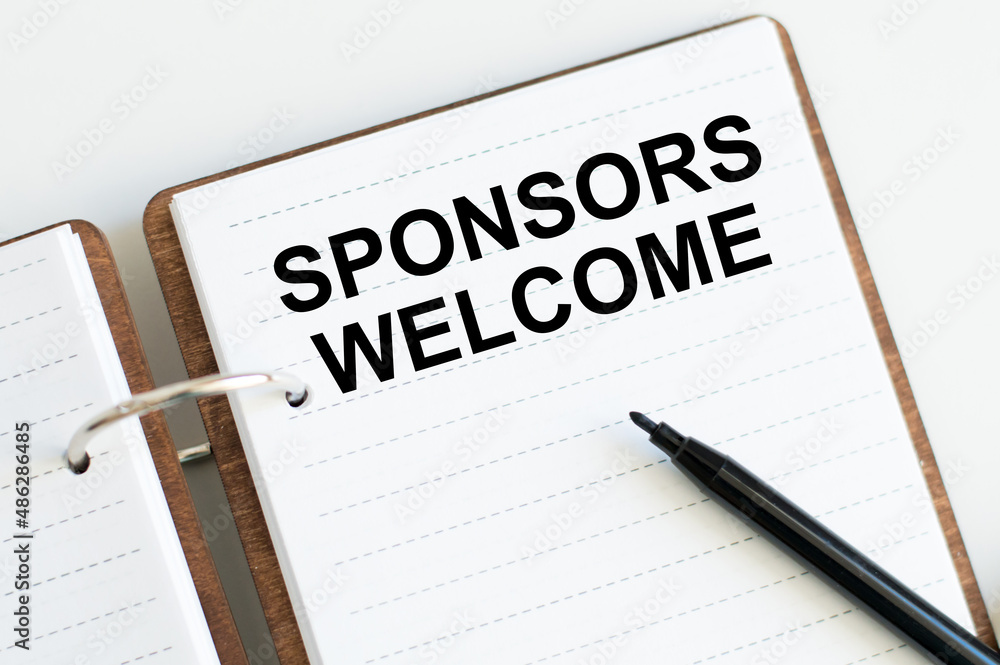 Sponsors Welcome text on an open notebook on a desk, a business concept Sponsors Welcome text on an open notebook on a desk, a business concept