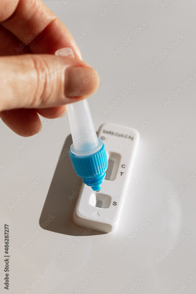 conducting a covid and disease test with a set and arm on a white background