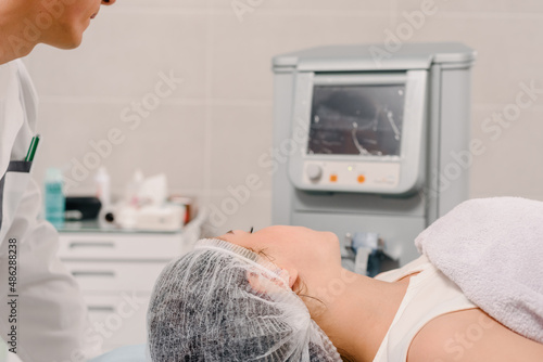 Young woman doing thermage procedure for skin tightening and wrinkle reduction