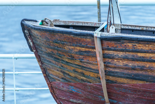 Photography Wooden old iconic lifeboat on a ship vessel.