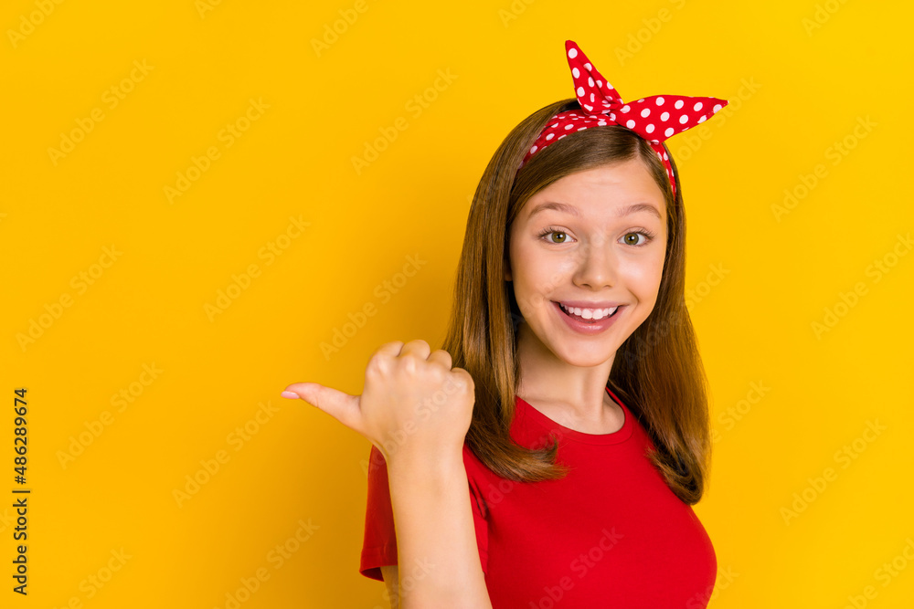 Photo of adorable pretty crazy girl advertising product black friday sale bargain isolated on yellow color background Photo of adorable pretty crazy girl advertising product black friday sale bargain isolated on yellow color background