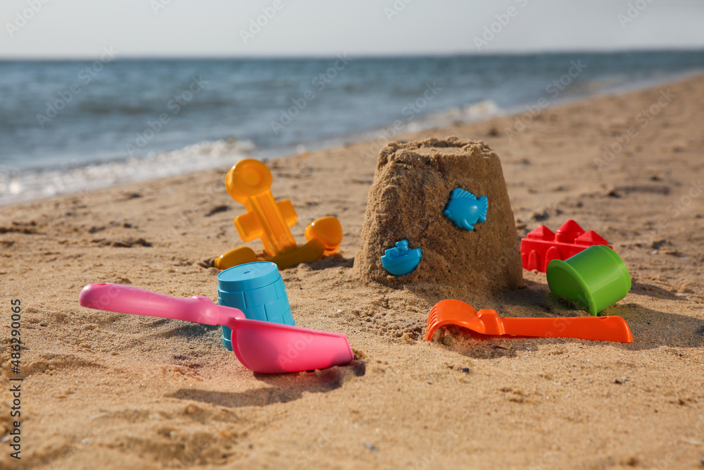 Set of plastic beach toys on sand near sea. Outdoor play Set of plastic beach toys on sand near sea. Outdoor play