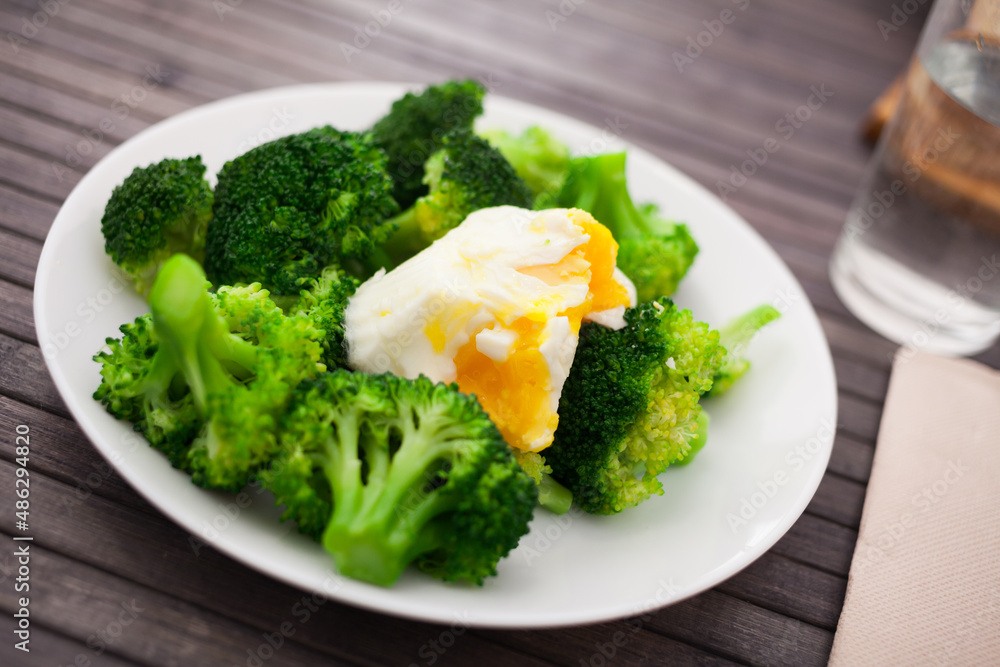 boiled broccoli inflorescences with boiled egg in plate boiled broccoli inflorescences with boiled egg in plate
