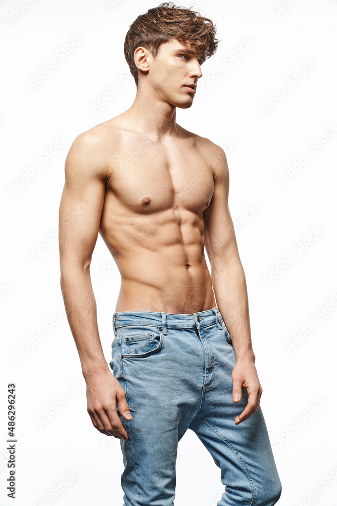 Portrait of sexy man in jeans isolated on white background