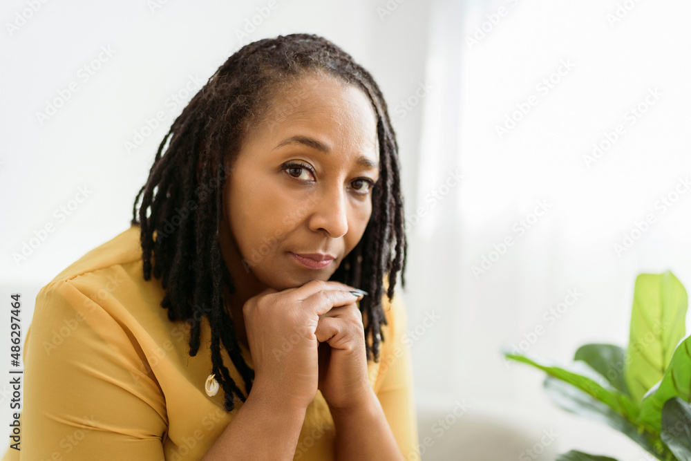 Portrait of an african woman sit on the sofa look worry Portrait of an african woman sit on the sofa look worry