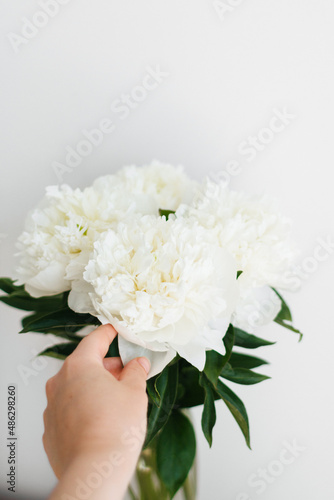 bouquet of white peonies in hand © Olga