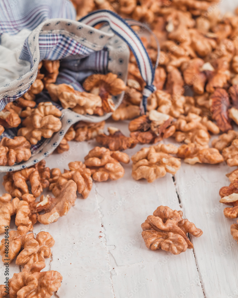 Fresh walnut kernels in eco bag on a wooden background. Organic food concept. Fresh walnut kernels in eco bag on a wooden background. Organic food concept.