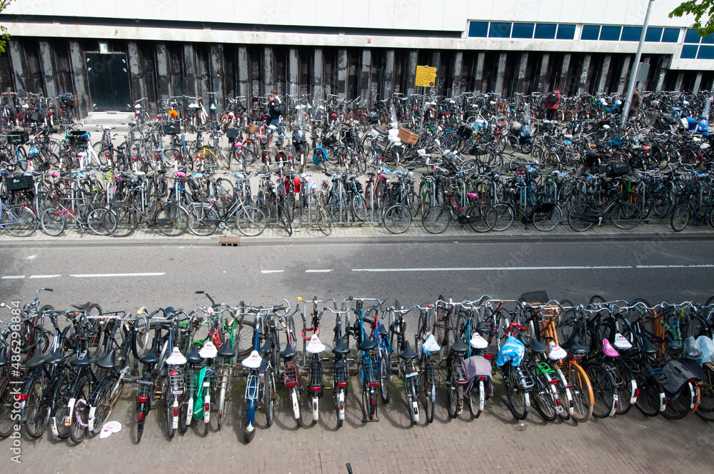 Obraz premium Hundreds of bicycles in a parking area in the center of Amsterdam, Netherlands.