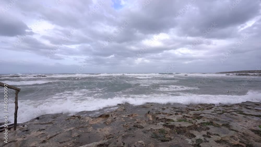 Waves crashing onto rocky coastline. Panning shot. Waves crashing onto rocky coastline. Panning shot.