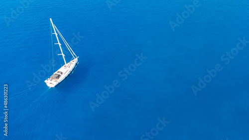 aerial view of couple enjoying sunbathing on the luxury yacht moving in the sea. Travel vacation. © Angelov