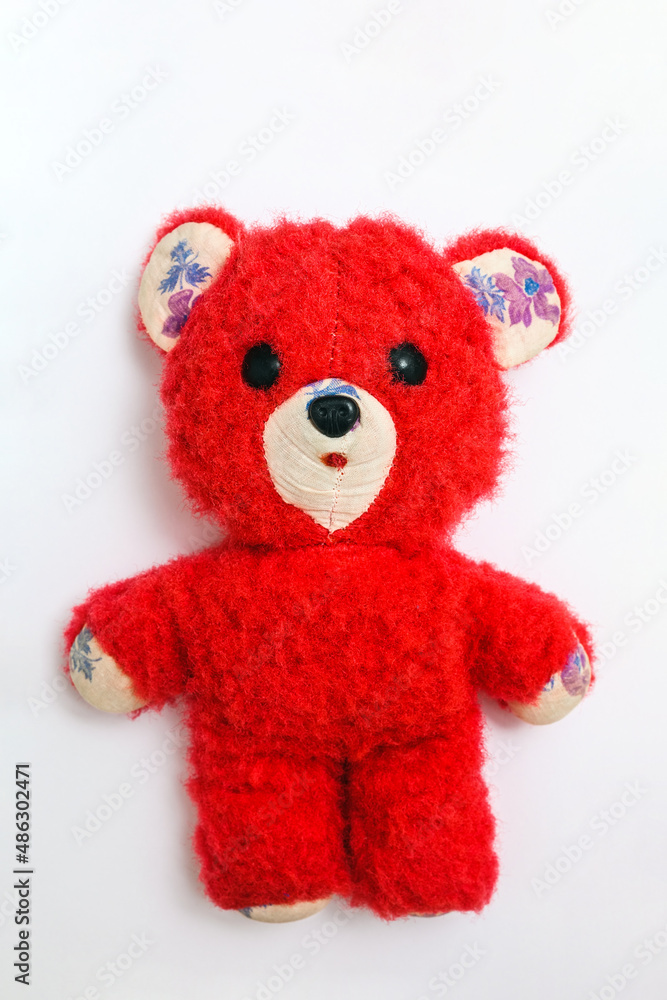 old soft toy - red teddy bear on a white background old soft toy - red teddy bear on a white background