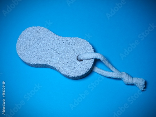 Fotografie Bathroom spa foot scrubber for removing dead skin isolated on blue background