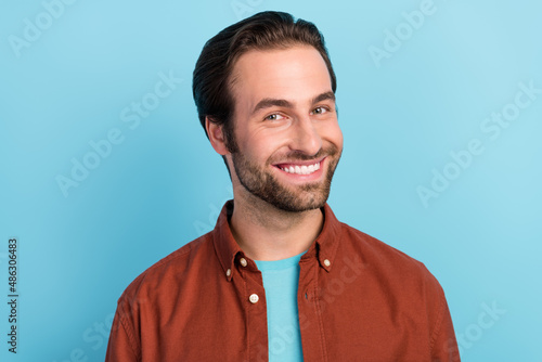 Photo of handsome bristle bearded man smiling stomatology treatment white veneers isolated on blue color background