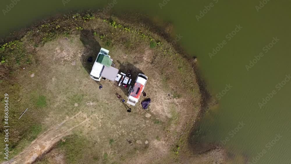 Aerial top view of camper near a lake on sunny summer day Aerial top view of camper near a lake on sunny summer day