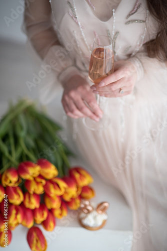 beautiful girl with long hair sits with a glass of champagne