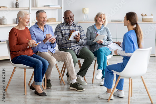 multiethnic group of elderly men and women having educational class