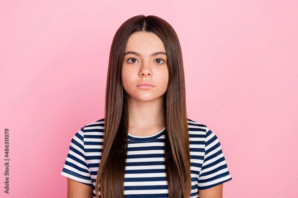 Photo of serious confident pretty cute school girl wear striped outfit isolated pink color background Photo of serious confident pretty cute school girl wear striped outfit isolated pink color background