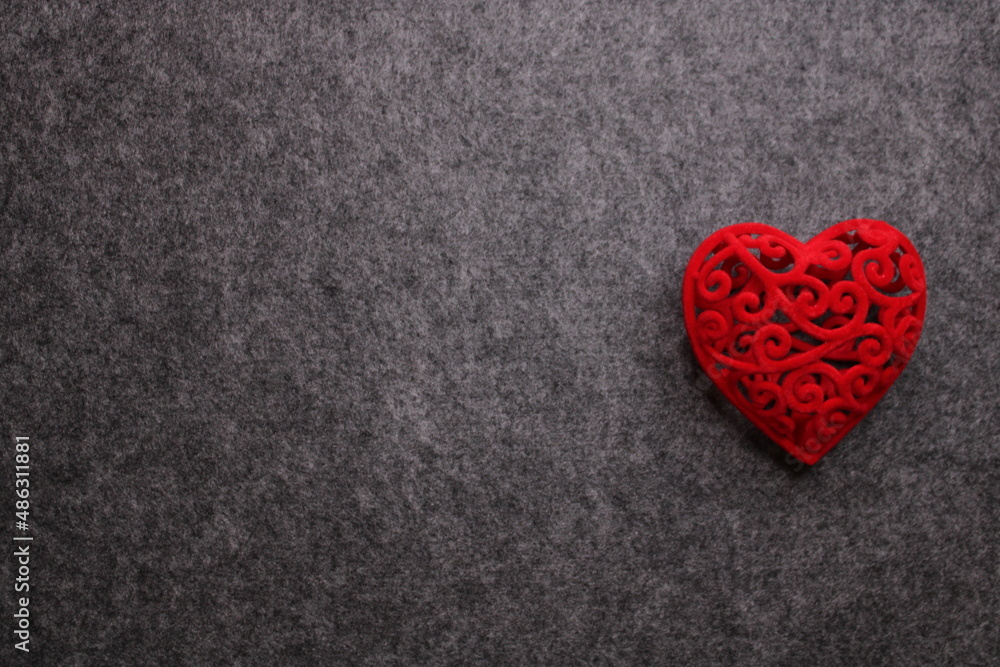 Conceptual dark gray background for Valentine's Day with a red heart with free space for an inscription. Conceptual dark gray background for Valentine's Day with a red heart with free space for an inscription.