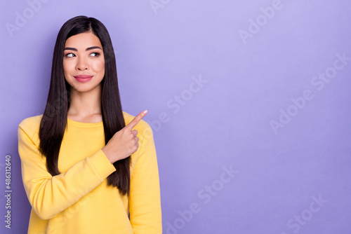 Photo of good mood interested funny girl look blank space promote product suggestion isolated on violet color background