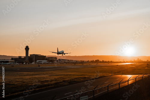 Airplane over PDX landing in the sunset photo