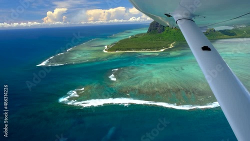 View of mauritius ocean coast, underwater watefall and Le Morne mountain from float plane cabin