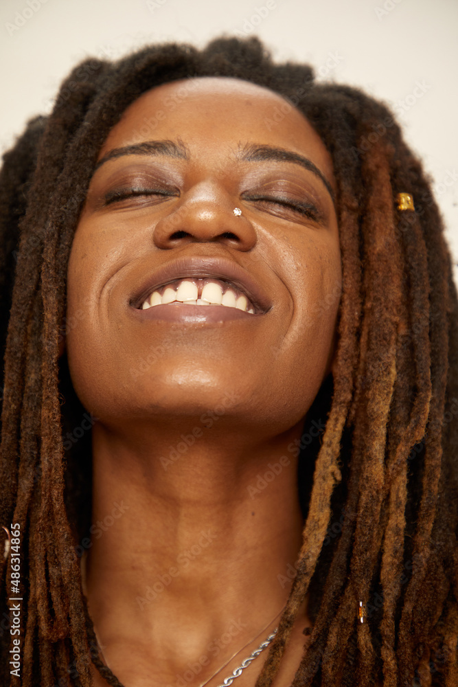 Close-up of smiling woman with dreadlocks Close-up of smiling woman with dreadlocks