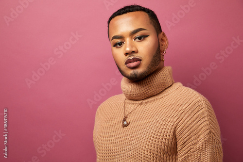 Studio portrait of queer man against purple background photo