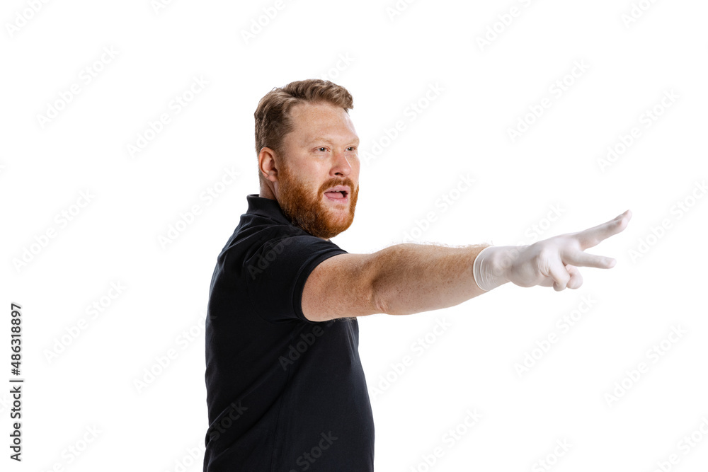 Studio shot of sport referee wearing black t-shirt referees the game isolated on white studio background. Concept of sport, rules, competitions, rights, ad, sales. Studio shot of sport referee wearing black t-shirt referees the game isolated on white studio background. Concept of sport, rules, competitions, rights, ad, sales.