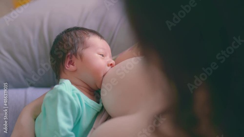 Mother and Newborn Baby. Happy Mother holding New born Baby girl kissing and hugging. Maternity concept. Parenthood. Motherhood. Beautiful Happy Family, togetherness, childhood and motherhood photo