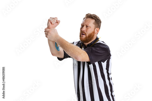 Half-length portrait of sport referee wearing field judge uniform gesturing isolated on white studio background. Concept of sport, rules, competitions, rights, ad, sales.