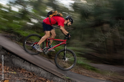 Man mountain biking going down hill