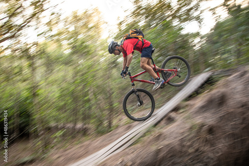 Man mountain biking going down hill