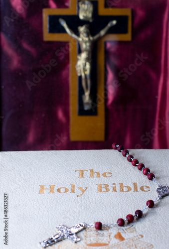 front cover detail of old holy bible with jesus on cross