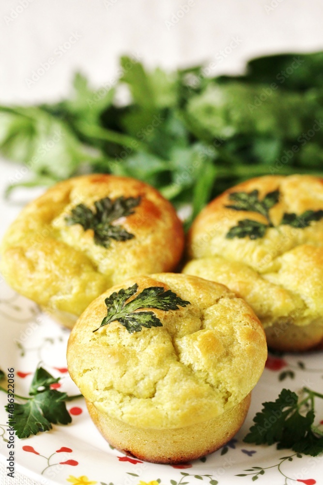 Fototapeta premium Patrick's Day Buns or muffins of green color with spinach juice of a trefoil of parsley leaves.