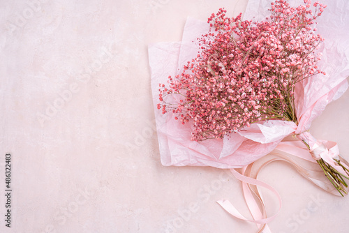 Pink Gypsophila flowers in paper wrapping photo