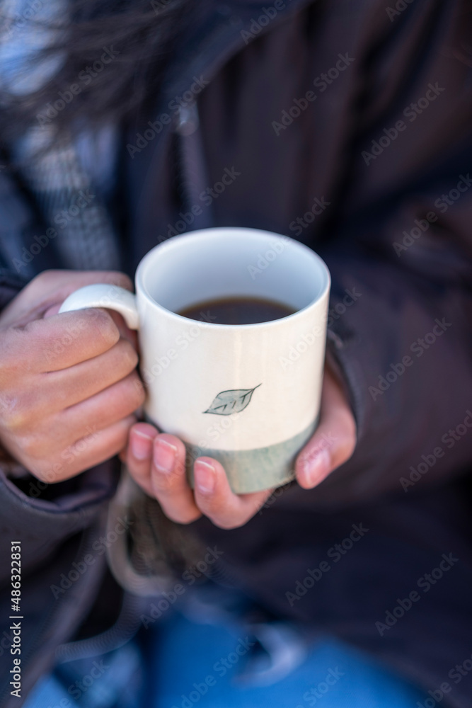 Woman holding mug with hot drink Woman holding mug with hot drink