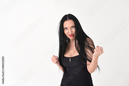 Fotografie Portrait of a beautiful brunette woman in an explosive fighting pose ready to fi