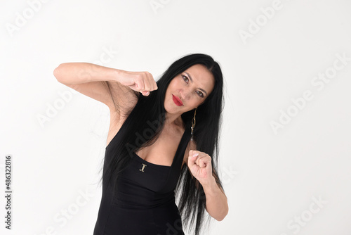 Obraz na płótnie Portrait of a beautiful brunette woman in an explosive fighting pose ready to fi