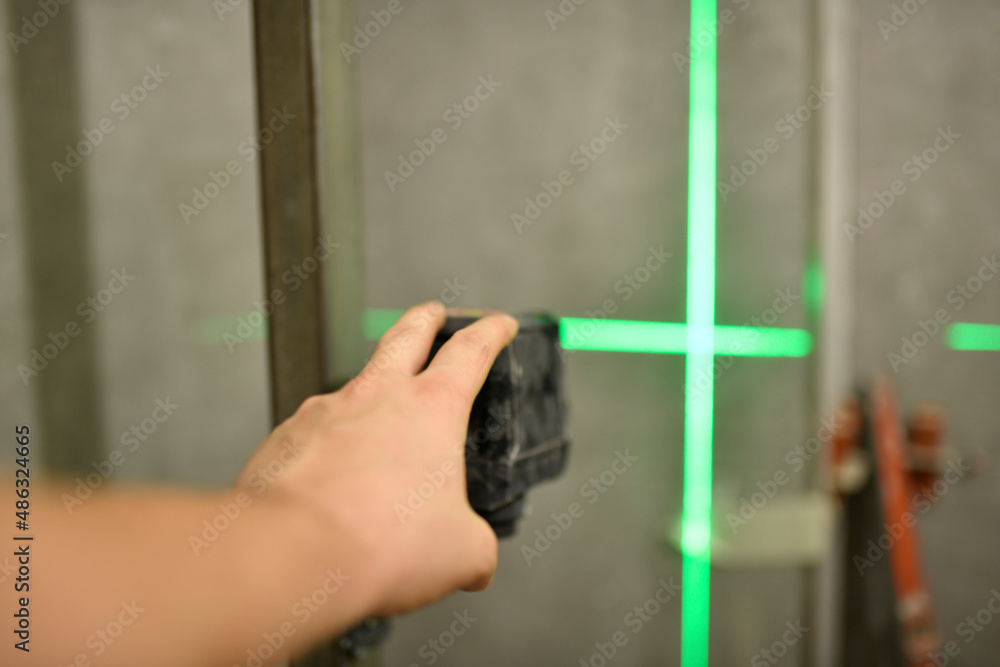 man's hand placing a laser level in a work or renovation in a house