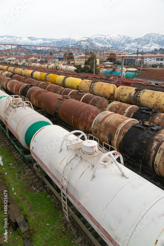 Railroad cars on a railway station. Cargo transportation. Storm clouds above train. Vertical photo