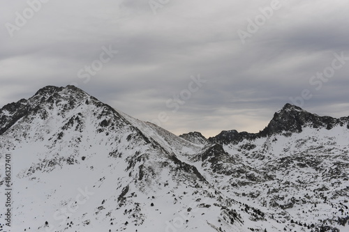 Pyrenees mountains range in winter with snowy peaks in Grandvalira ski paradise resort in Andorra