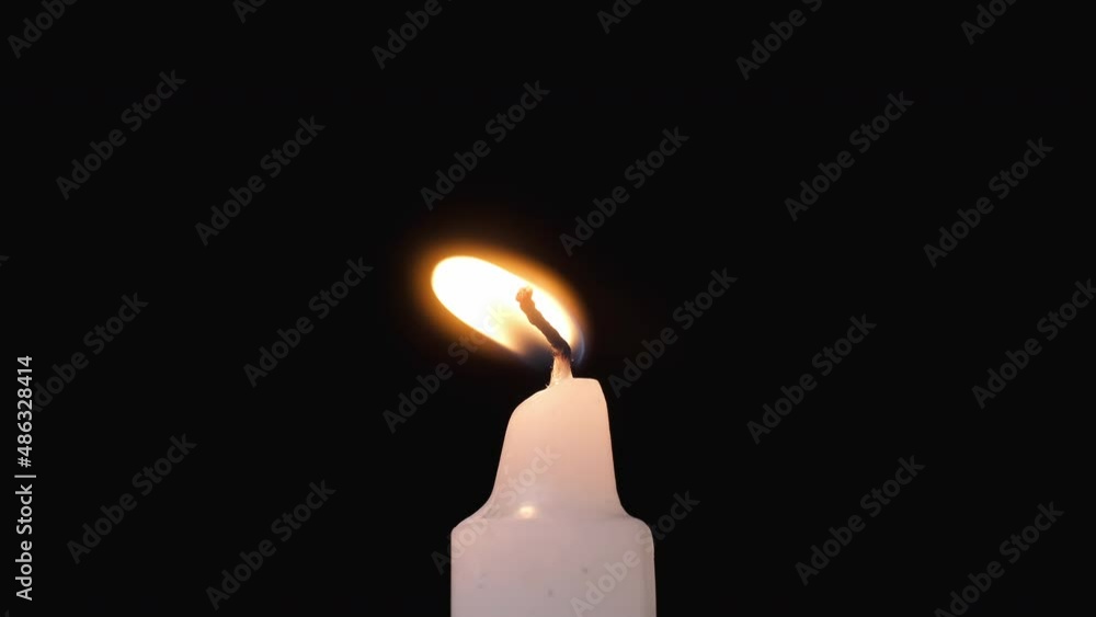 Candle flame lights and is blown out. Central framing. Candle at black background. 4K, UHD Candle flame lights and is blown out. Central framing. Candle at black background. 4K, UHD