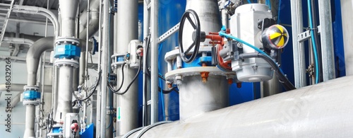 Large industrial water treatment and boiler room. Piping, valves, flanges