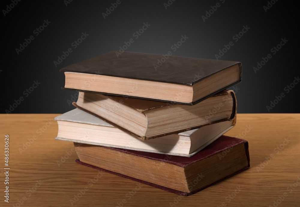 Stack of old worn shabby books in leather binding in the dark. Stack of old worn shabby books in leather binding in the dark.