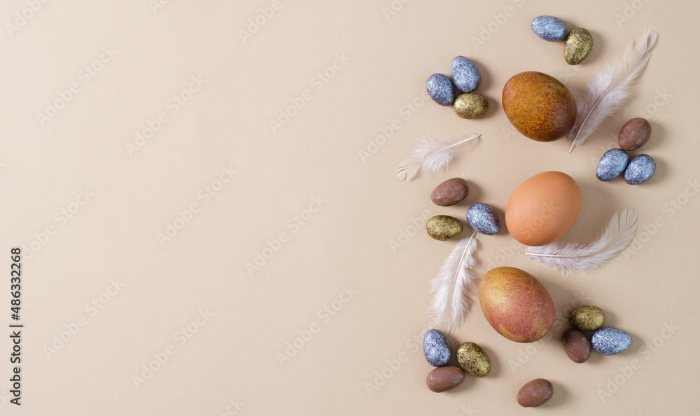 Natural Easter eggs with small candies of dragees. Easter eggs on a beige background with dragees copy space.