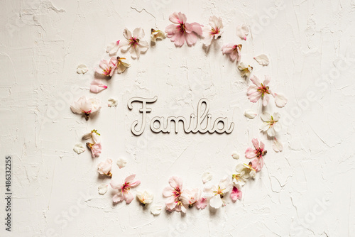 White background of almond flower crown with words written on white wood 