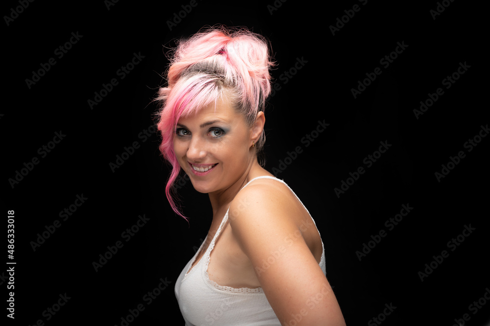 Caucasian blonde woman with pink hair and green eyes smiling at camera looking sideways. Caucasian blonde woman with pink hair and green eyes smiling at camera looking sideways.