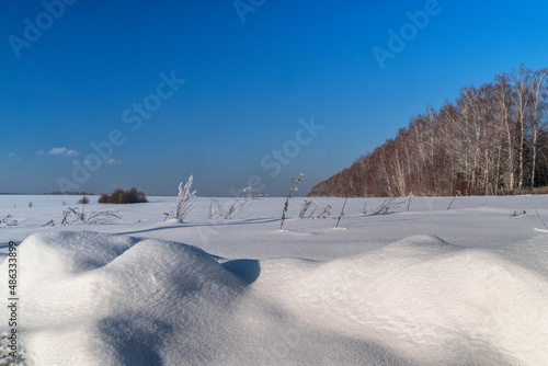 Winter landscape in countryside with white snow on the foreground.